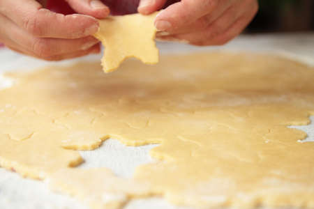 Making cookies on  kitchen table, Roll out the dough and molds to cut , Selective focus , cropped...