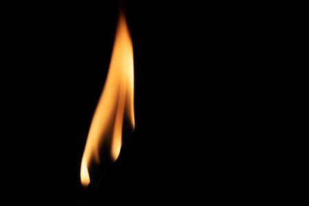 Match with strongly flaring flame on a black background closeupの写真素材
