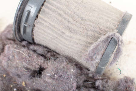Common household dust on HEPA (High efficiency particulate air) filter from the vacuum cleaner.  macro view, isolated on a white backgroundの写真素材
