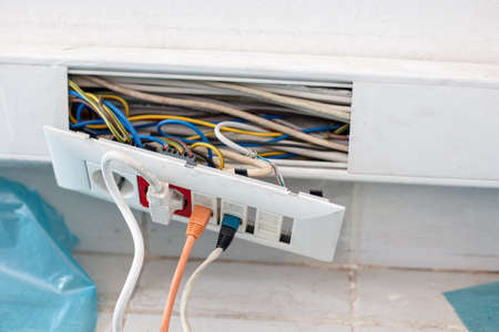 Plactic  cable channel while  repairing  with electrical outlets on  where two ethernet cables and...