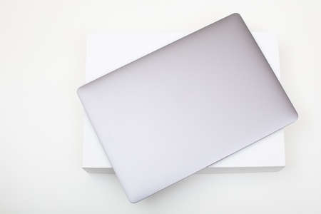New high-speed thin grey aluminum laptop computer notebook top view with box isolated on a white...