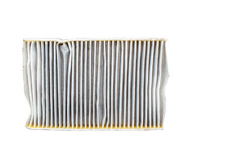Changing a  car cabin pollen filter . High efficiety particle air filter.(Old one - back side) white background cutoutの写真素材