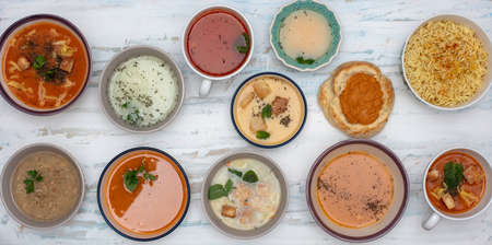 Set of soups from worldwide cuisines, Fresh and healty soups on painted background,  Top viewの写真素材