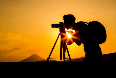 photographer at sunset silhoutteの写真素材
