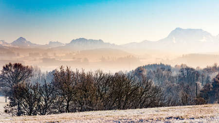 Winter landscape hazy and mist in Bavaria mountains panoramaの写真素材