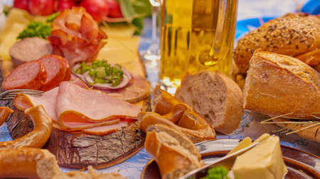 Sausage plate with beer, ham, butter and pretzels and breadの写真素材