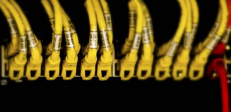 Network hub and patch UTP LAN cables in rack cabinet, close up. Network hub and patch UTP LAN cables...