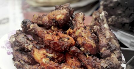 Close up barbecue chicken wings close up on wooden tray shot with selective focus.の写真素材