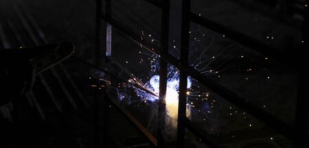 Metal welding. Sparks from electric heating. Work in the workshop. Creation of reliable fastening of...