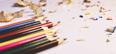 Close-Up Of Colored Pencils With Shavings On White Background. Art, inspiration, creativity concept. Selective focus.Copy space for text.の写真素材