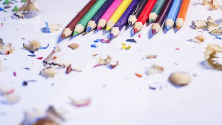 Heap of colorful wood pencils and shavings on a white background.Concept for Business and Education.Selective focus with copy space for text.の写真素材