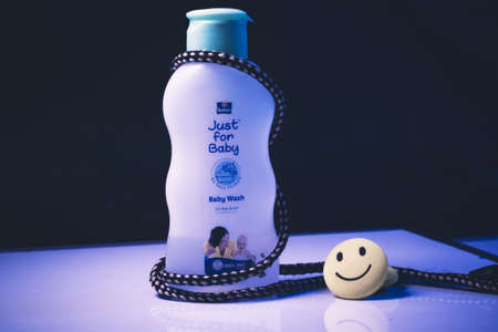Dhaka,Bangladesh-February 26,2020 : Baby oil moisturizer cream for whole body with a happy smile.のeditorial素材