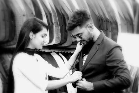 Dhaka,Bangladesh-March 25,2020 : Young lady help her lover to trail a new brand blazer on shop.のeditorial素材