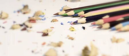 Various Color of Wooden Pencils and Shavings Top Corner View on a Pure White Background.Sorted Colorful Pencils with Selective Focus on Subject.Blurry Background Heap of Colorful Pencils with Copy Space For Text .の写真素材