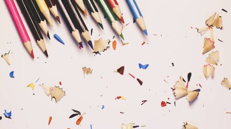 Various Color of Wooden Pencils and Shavings Top Corner View on a Pure White Background.Sorted Colorful Pencils with Selective Focus on Subject.Blurry Background Heap of Colorful Pencils with Copy Space For Text .の写真素材