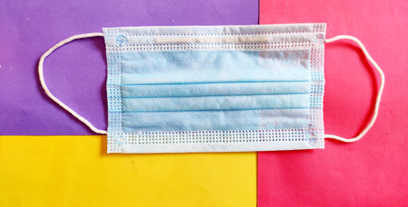 Medical protective face mask on different color background, personal hygiene, health care, corona virus, covid 19, medical.Top view.の写真素材