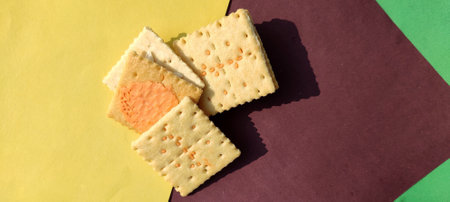 Square cookies on multi color background. Nutritious foods associated with protein and fiber.Close-up top view, concept of food.の写真素材