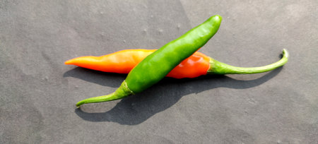 chili red and green color mixed on a grey background,selected focus with copy space for text.