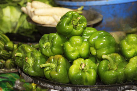 Close up view of green capsicum in a local market.の写真素材