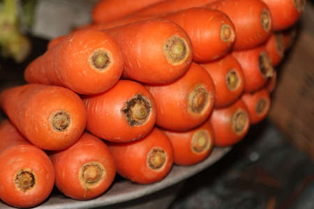 Fresh carrots close up view selling in a local market.Organic and healthy carrots piled at the market.の写真素材