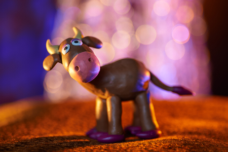 merry plasticine cow from Christmas series on blurred backgroundの写真素材