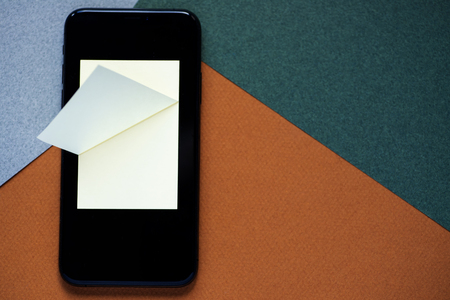 notebook for records in the phone to save information in memory, on a colored backgroundの写真素材