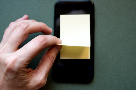 notebook for records in the phone to save information in memory, on a colored backgroundの写真素材