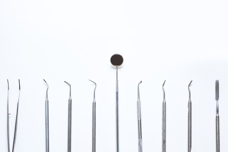 various dental tools laid out flatlay on a light backgroundの写真素材