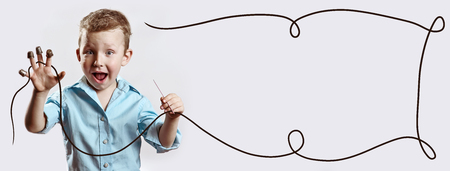 boy with a needle and thread in a blue shirt on a light backgroundの写真素材