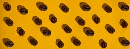 the pattern of coffee beans on bright colored backgroundの写真素材