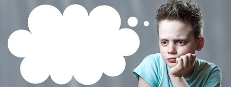 a boy in a bright t-shirt offended and crying looking in the direction of
