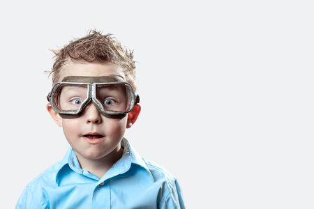 boy in blue shirt and pilot glasses on a light backgroundの写真素材