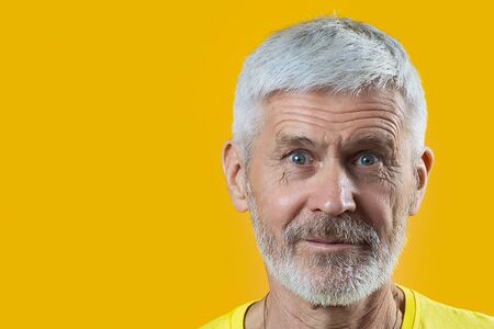 portrait of a gray-haired man with a beard shows gesture good on a blue backgroundの写真素材