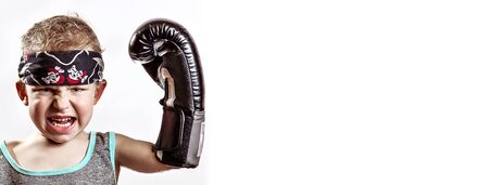 fighting emotional boy in Boxing gloves and bandana on light backgroundの写真素材