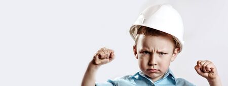 a boy in a light shirt and helmet Builder shows how he is strong and confidentの写真素材