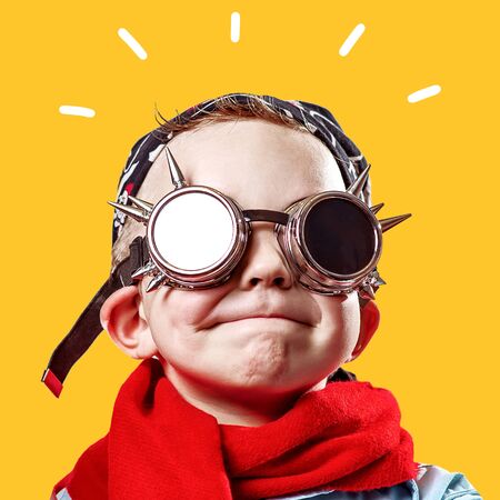 rocker boy in blue shirt, red scarf, biker glasses and bandana on bright background