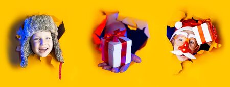 Several portraits little cheerful Santa in a hat smiles, getting out of the ragged yellow background lit by neon light. Large size of allの写真素材