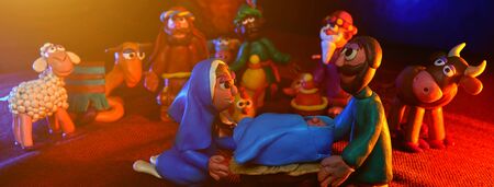many plasticine figures on the theme of Christmas with beautiful orange blue lightingの写真素材