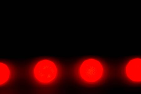 Abstract colored bokeh on a black backgroundの写真素材