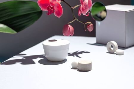 Composition on the table with cream and orchid flower. Concept on the theme of youth and beauty.の写真素材
