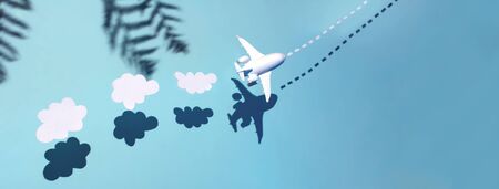 The white plane is flying across the ocean.