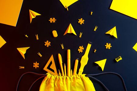Back to school. Black background with yellow school supplies: crayons, markers, ruler, paints. Copy space. Concept Flat layの写真素材