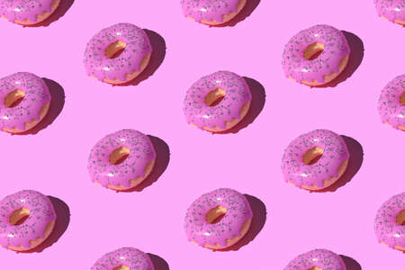 Pink glazed donut pattern on pastel background. Creative concept. 3d.