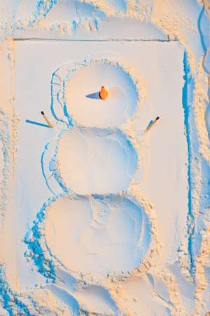 A snowman made of flour with carrots and matches. New Year's Concept Postcard 2021の写真素材