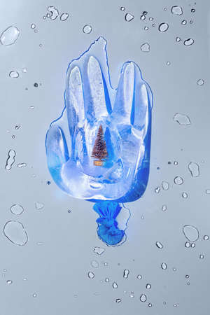 Christmas tree in ice medicine glove, new year 2021 conceptの写真素材