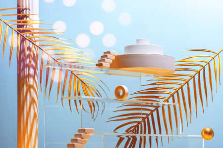 Monumental composition with catwalks, stairs, palm leaves and geometric shapes in blue and gold colors, beauty concept, mock up.の写真素材