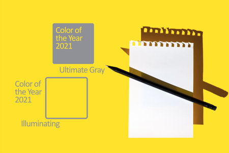 a blank sheet of Notepad, black pencil and hard shadows on a bright yellow background