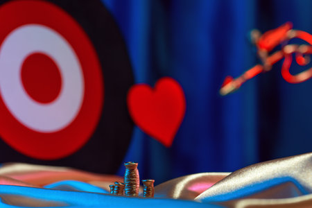 Small golden cupid marks his target with an arrow at the heart, valentines day concept.の写真素材