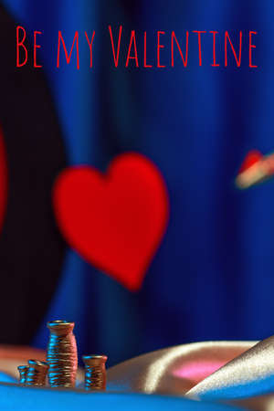 Small golden cupid marks his target with an arrow at the heart, valentines day concept.の写真素材