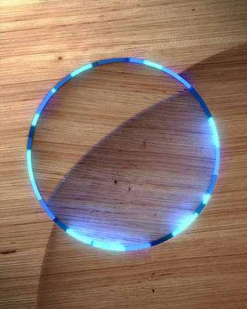 Digital illustration of abstract geometric wooden shape with a luminous ring in the center. Rounded...